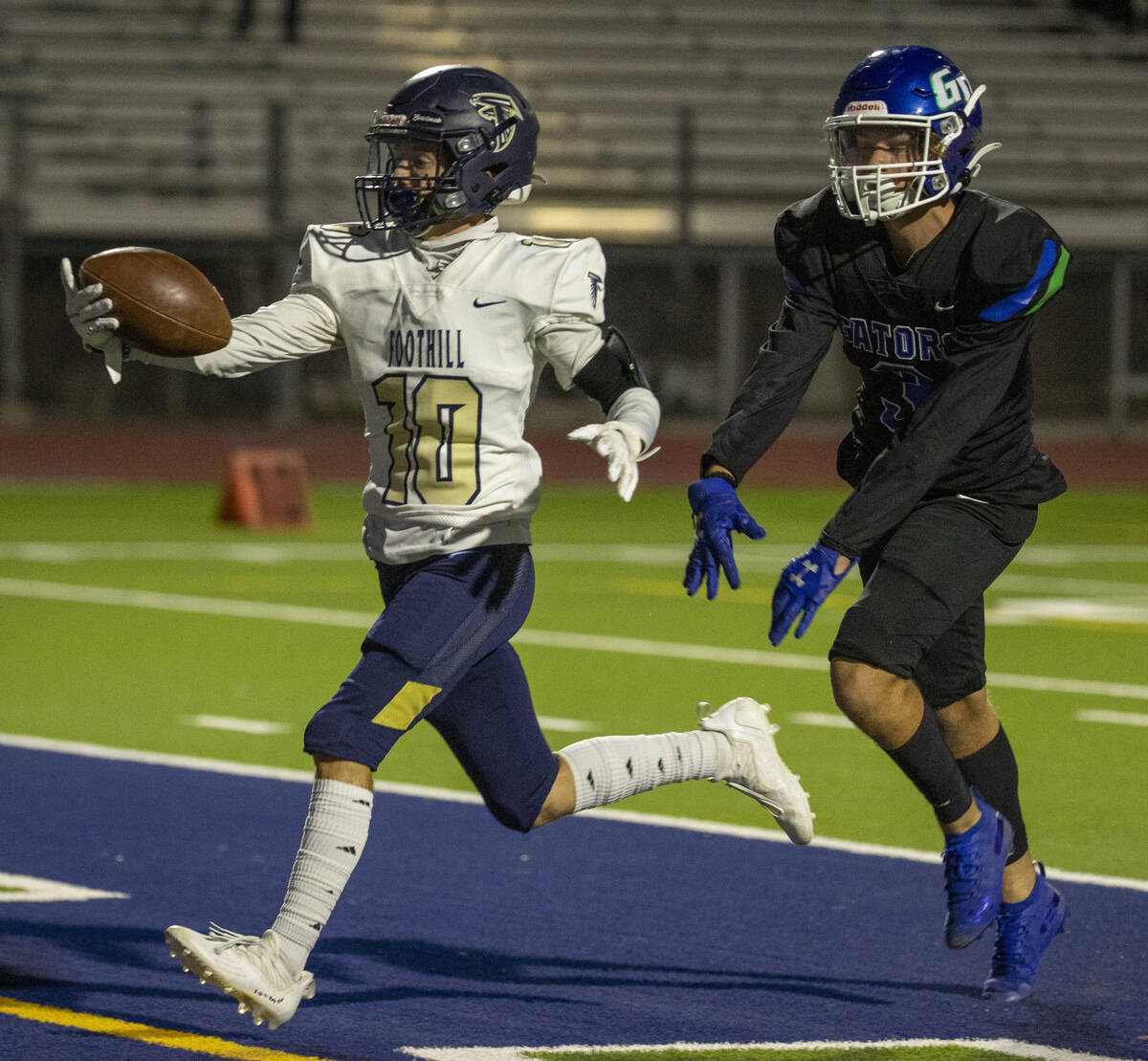 Foothill receiver Cole Reed (10) scores past Green Valley safety Blayne Reiner (3) during the f ...