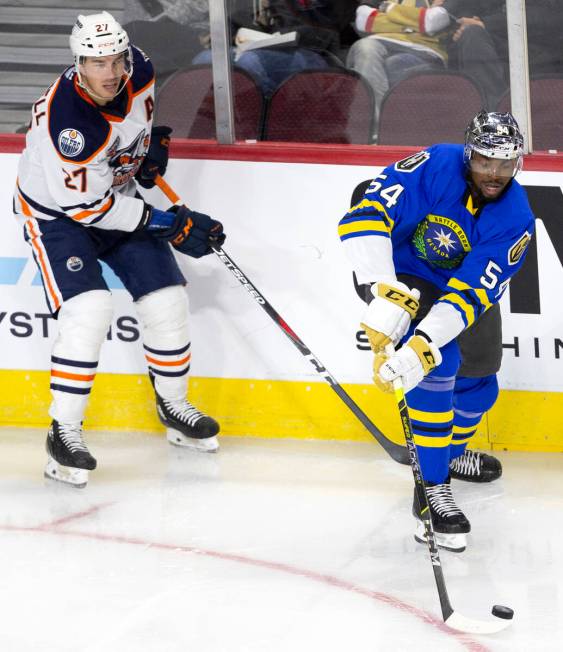 Henderson Silver Knights right wing Jermaine Loewen (54) and Bakersfield Condors center Adam Cr ...