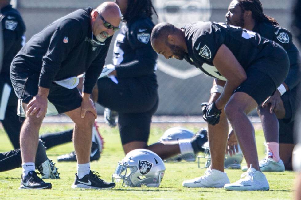 Raiders interim head coach Rich Bisaccia, left, shares a laugh with Raiders outside linebacker ...
