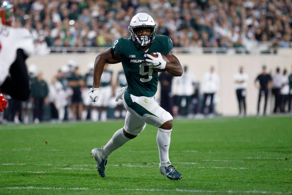 Michigan State running back Kenneth Walker III runs for a touchdown during an NCAA college foot ...