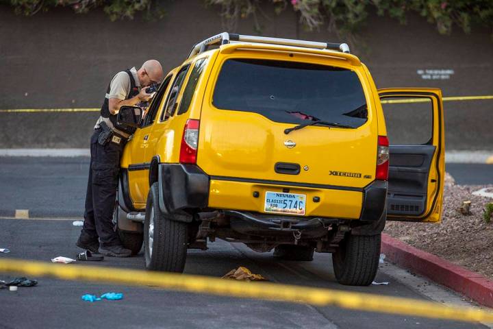 Metro Senior Crime Scene Analyst Joseph Szukiewicz works the scene of a homicide at the Solaire ...