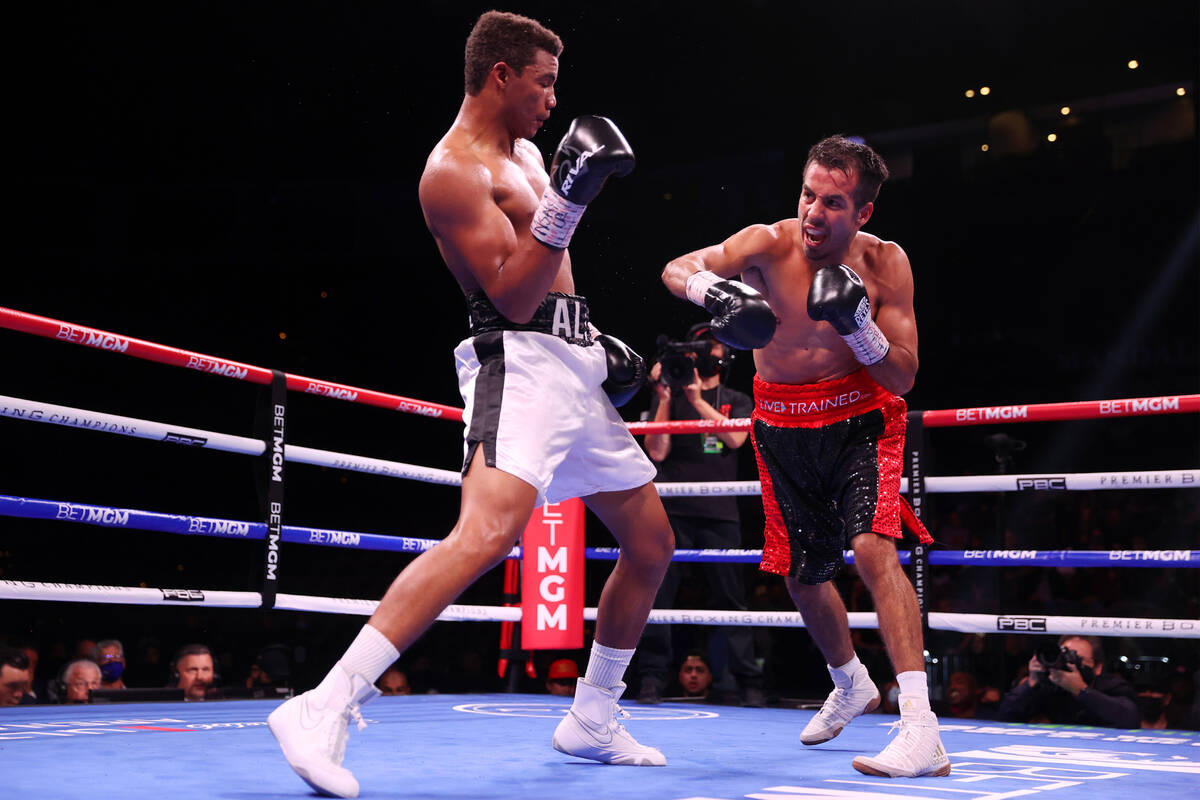Michel Rivera, left, moves away from a punch against Jose Matias Romero in the ninth round of a ...