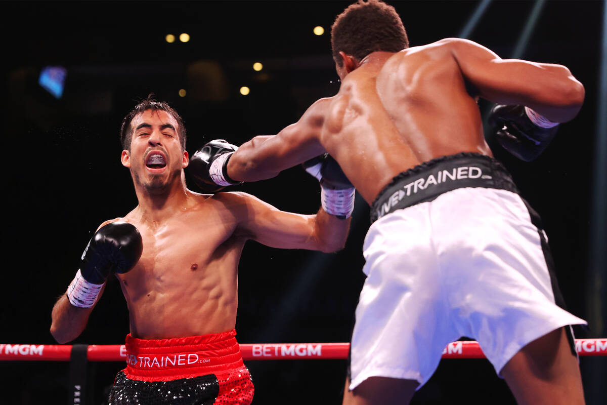 Michel Rivera connects a punch against Jose Matias Romero in the third round of a lightweight b ...