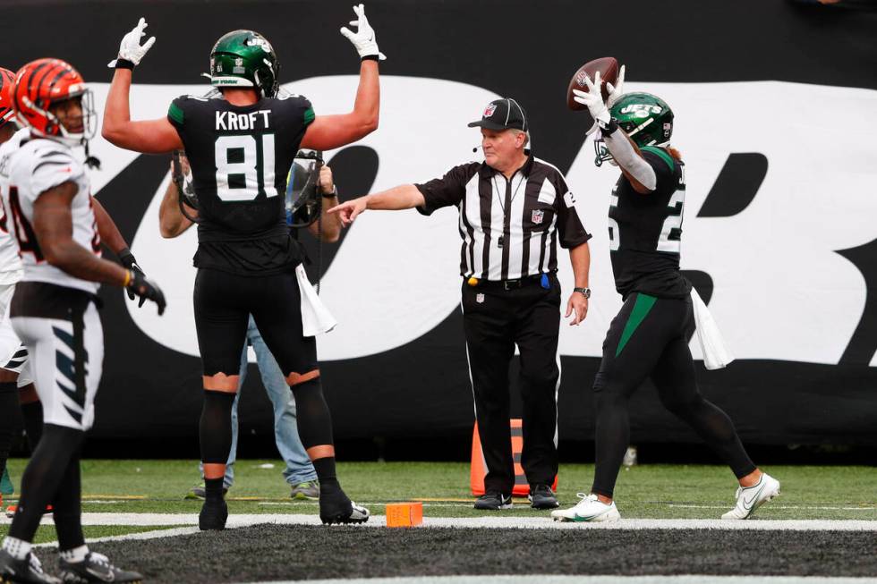 New York Jets' Ty Johnson, right, reacts after scoring a touchdown during the second half of an ...