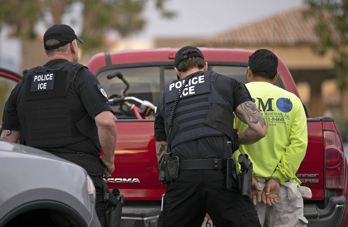 U.S. Immigration and Customs Enforcement (ICE) officers detain a man during an operation in Esc ...