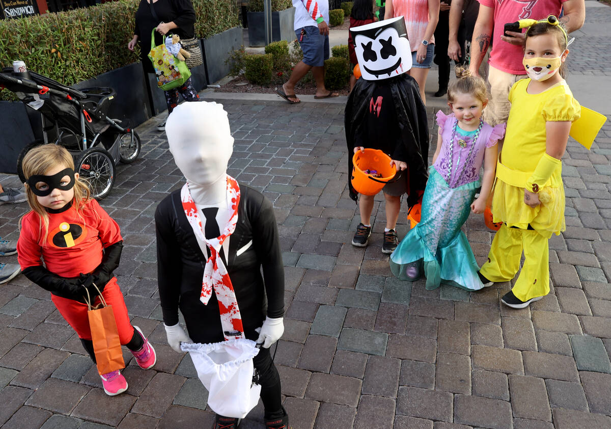 Sawyer, 3, left, and Liam Hagy, 7, of Henderson during the Halloween Ghost Walk at The District ...