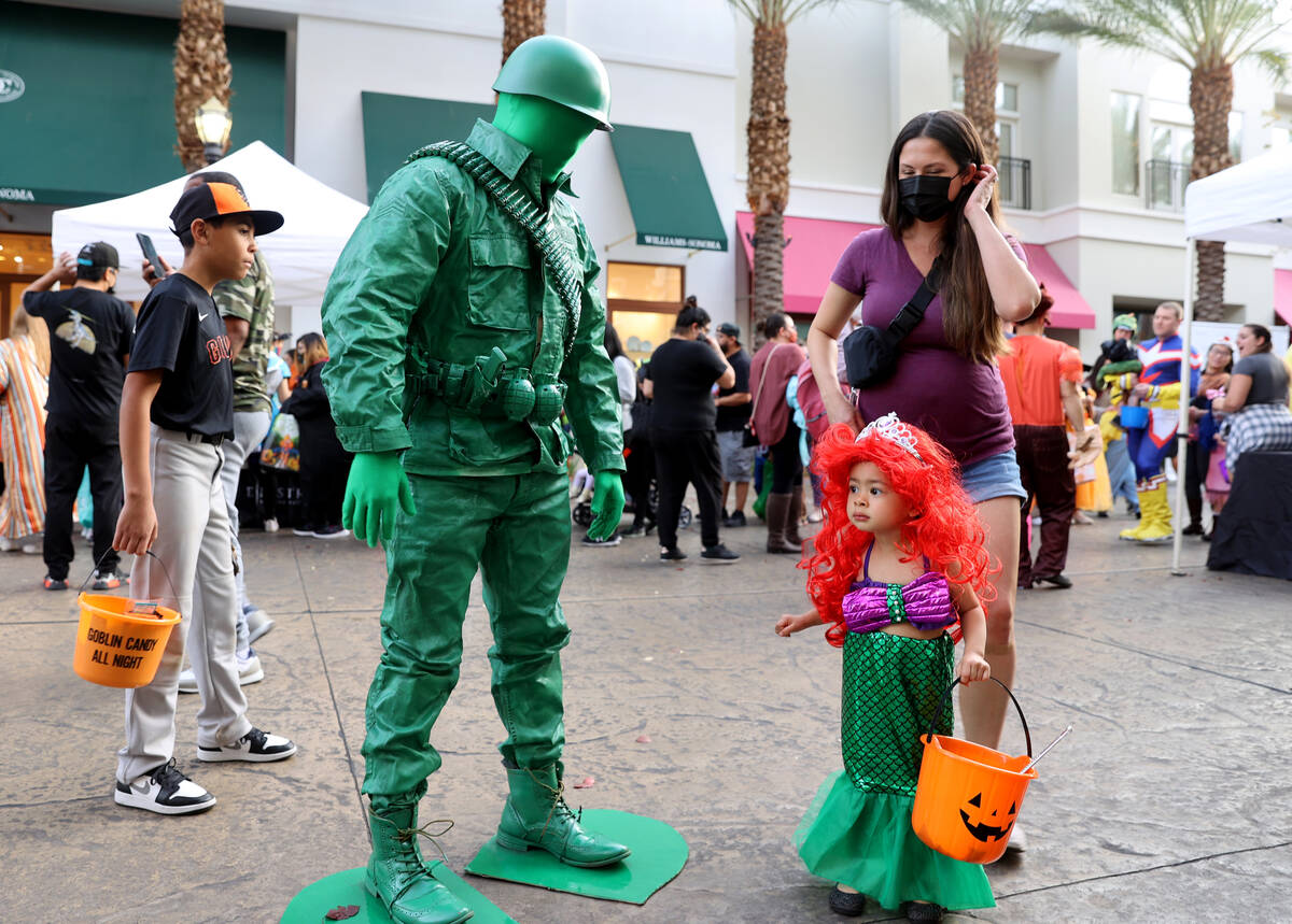Kevin Tay, left, and his daughter Mia, 2, of Henderson during the Halloween Ghost Walk at The D ...