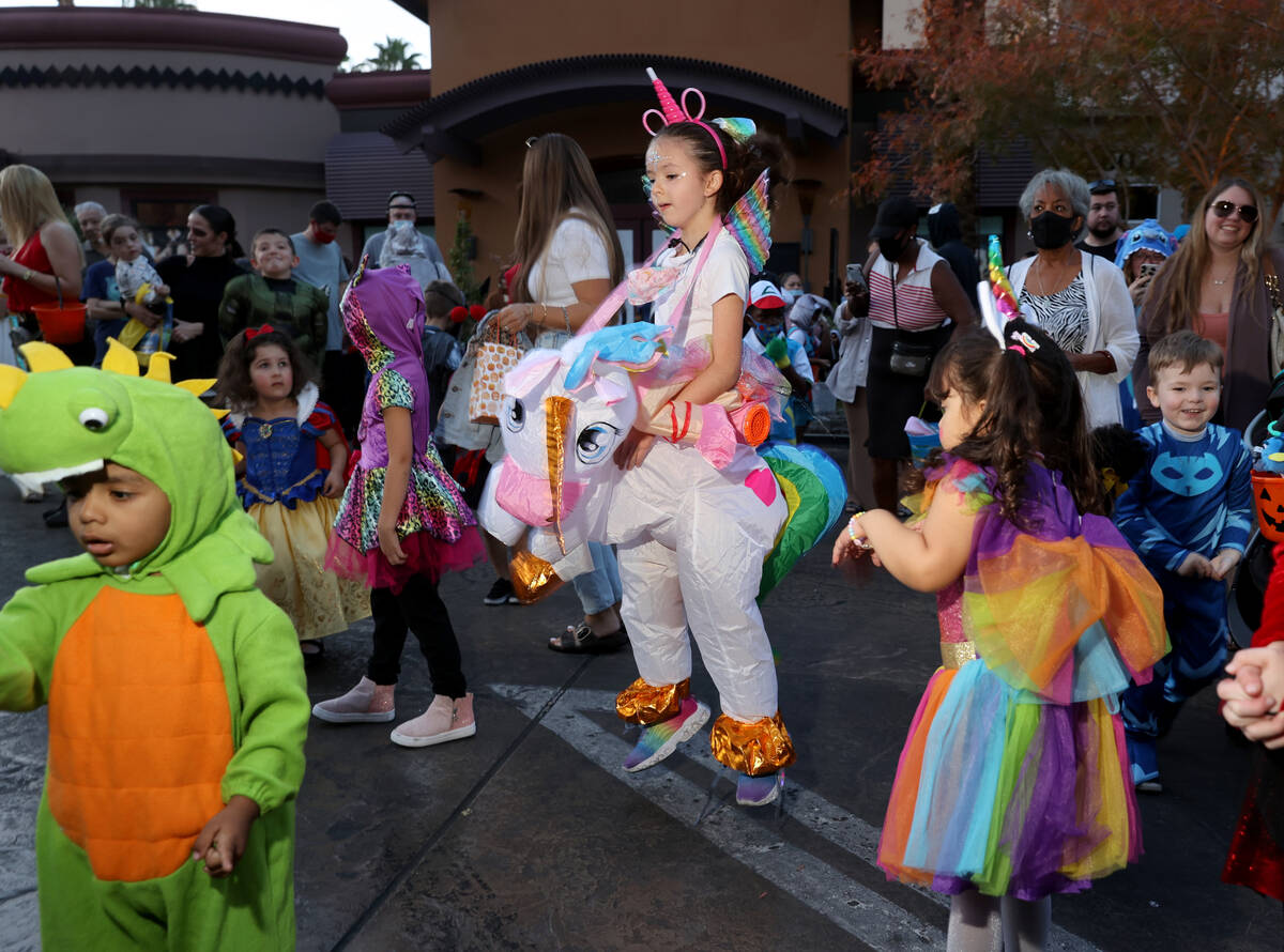 Beatrice Alves, 7, of Las Vegas gets airborne while dancing during the Halloween Ghost Walk at ...