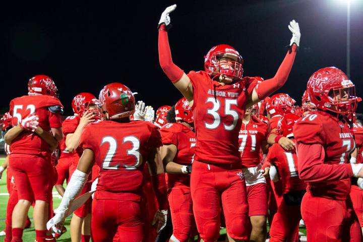 Arbor View players, including Jonathan Stites (35), celebrate a win against Desert Pines in a h ...