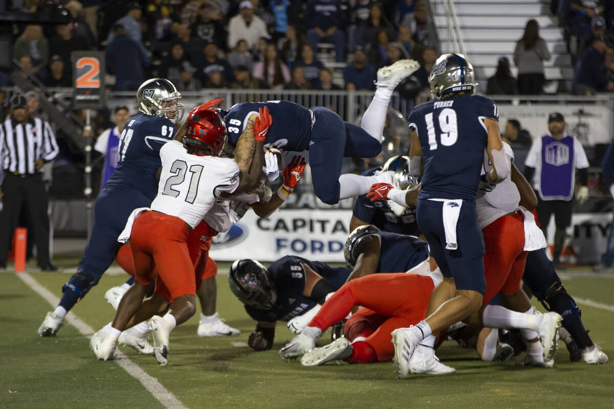 Nevada running back Toa Taua (35) is stopped at the goal line by UNLV in the first half of an N ...