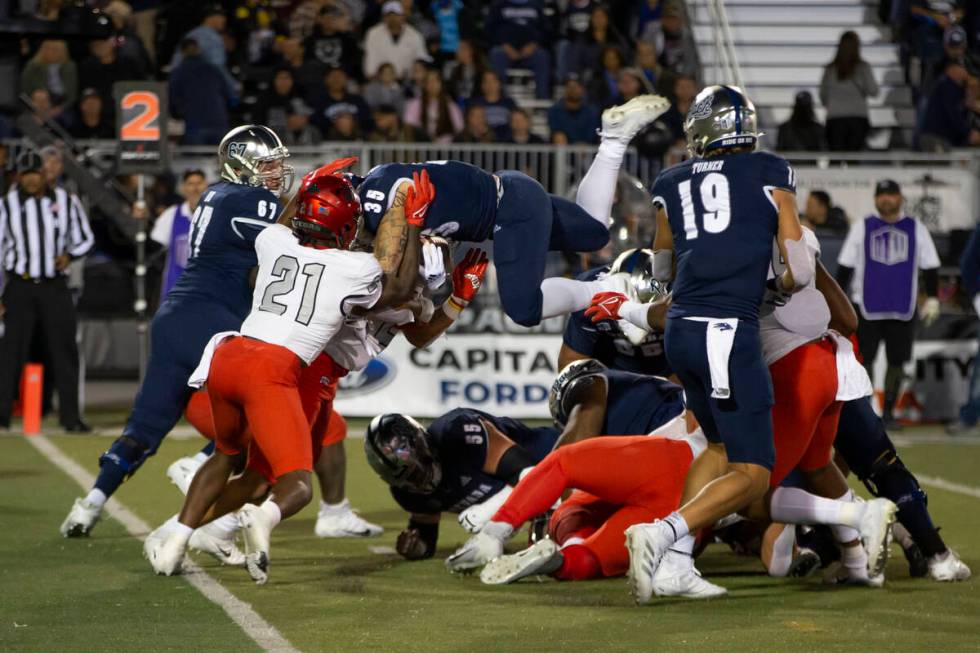 Nevada running back Toa Taua (35) is stopped at the goal line by UNLV in the first half of an N ...