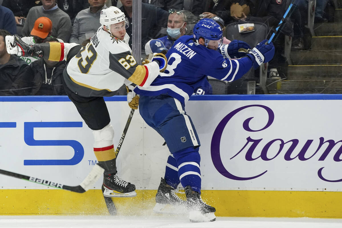 Vegas Golden Knights forward Evgenii Dadonov (63) dodges a check by Toronto Maple Leafs defense ...