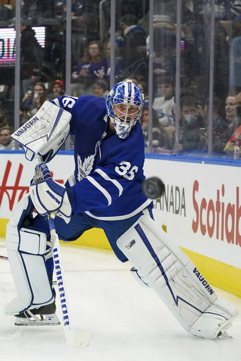 Toronto Maple Leafs goaltender Jack Campbell shoots the puck around the boards during the first ...