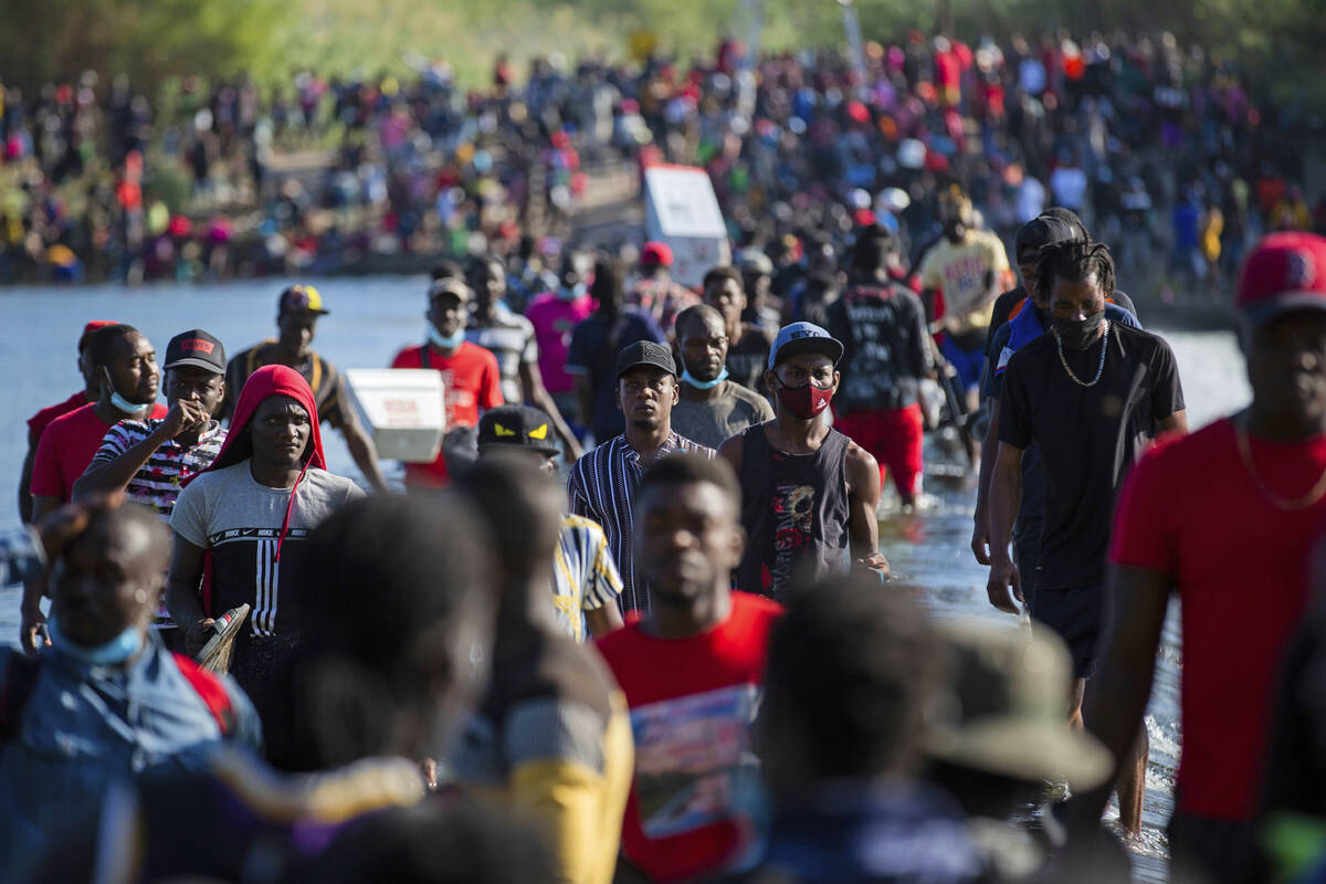 Haiti migrants waiting in Del Rio and Ciudad Acuña to get access to the United States, cro ...