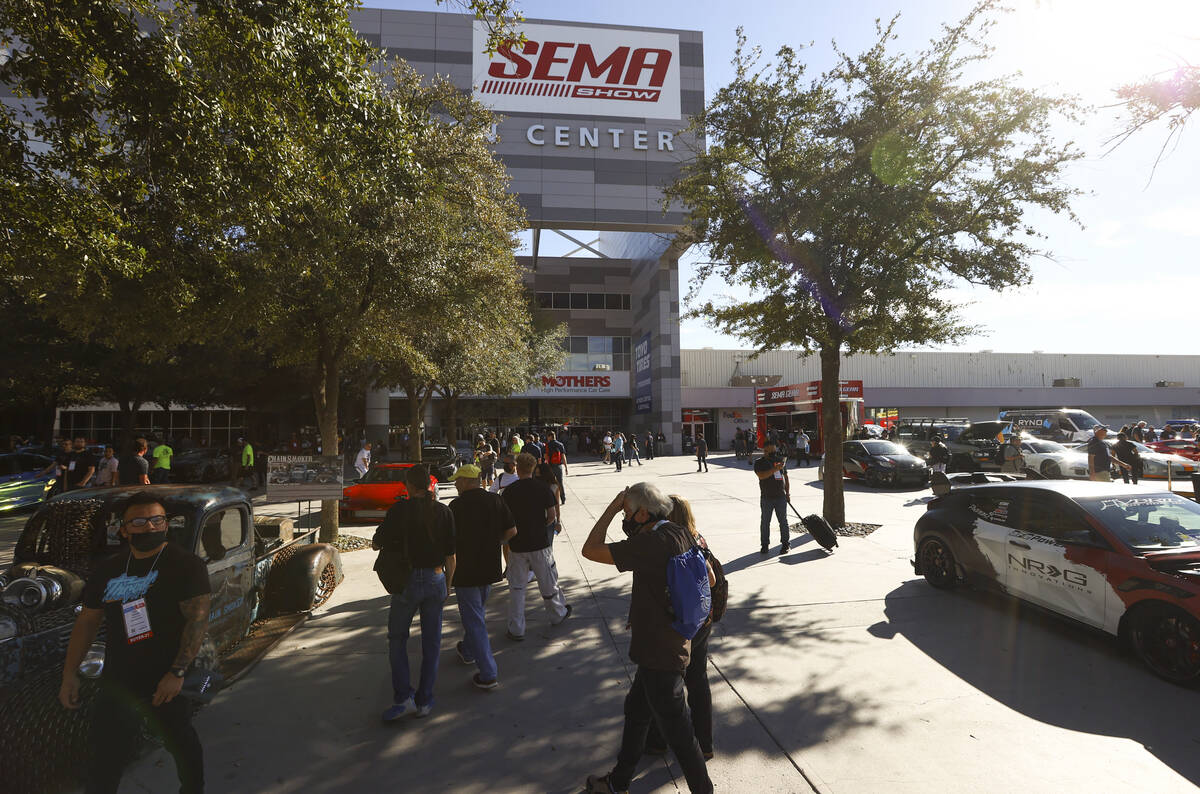Attendees of the the Specialty Equipment Market Association, or SEMA, Show walk around outside ...