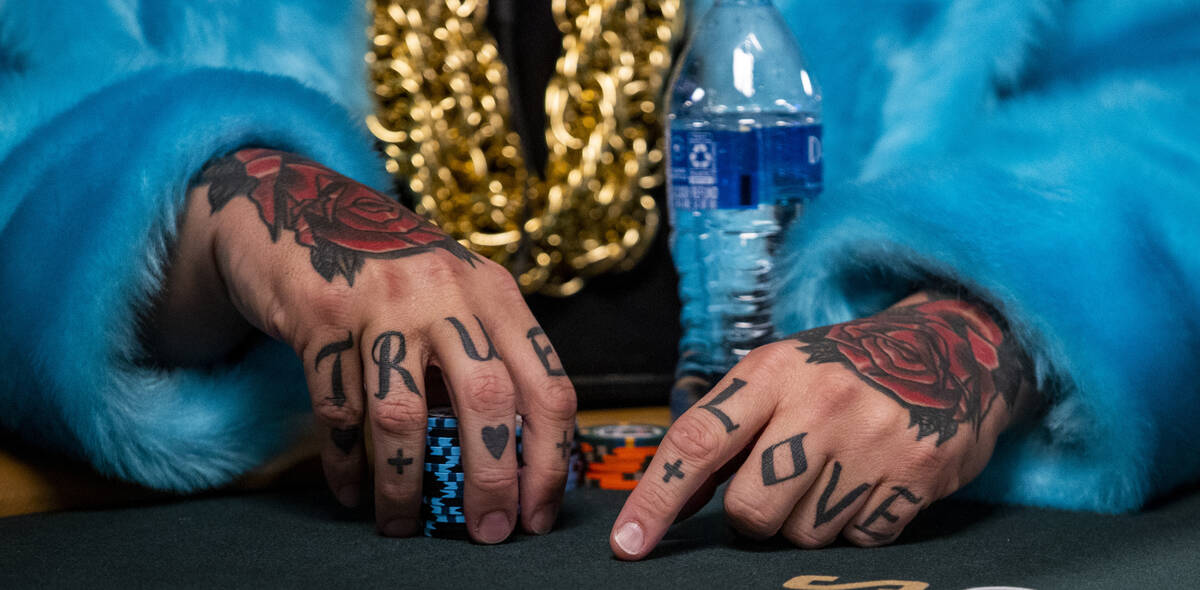 Ryan Snow of Atlanta sports a blue furcoat, gold chains and hand tattoos while playing at his t ...