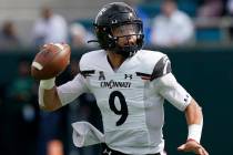Cincinnati quarterback Desmond Ridder (9) drops back to pass during the first half of an NCAA c ...
