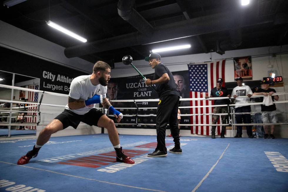 Caleb Plant, left, works on his defense with cutman Don House, at the City Boxing Club in Las V ...