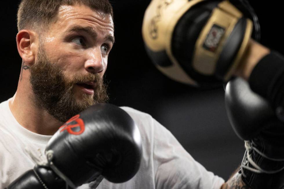 Caleb Plant, right, works on his punching combinations with trainer Justin Gamber, at the City ...