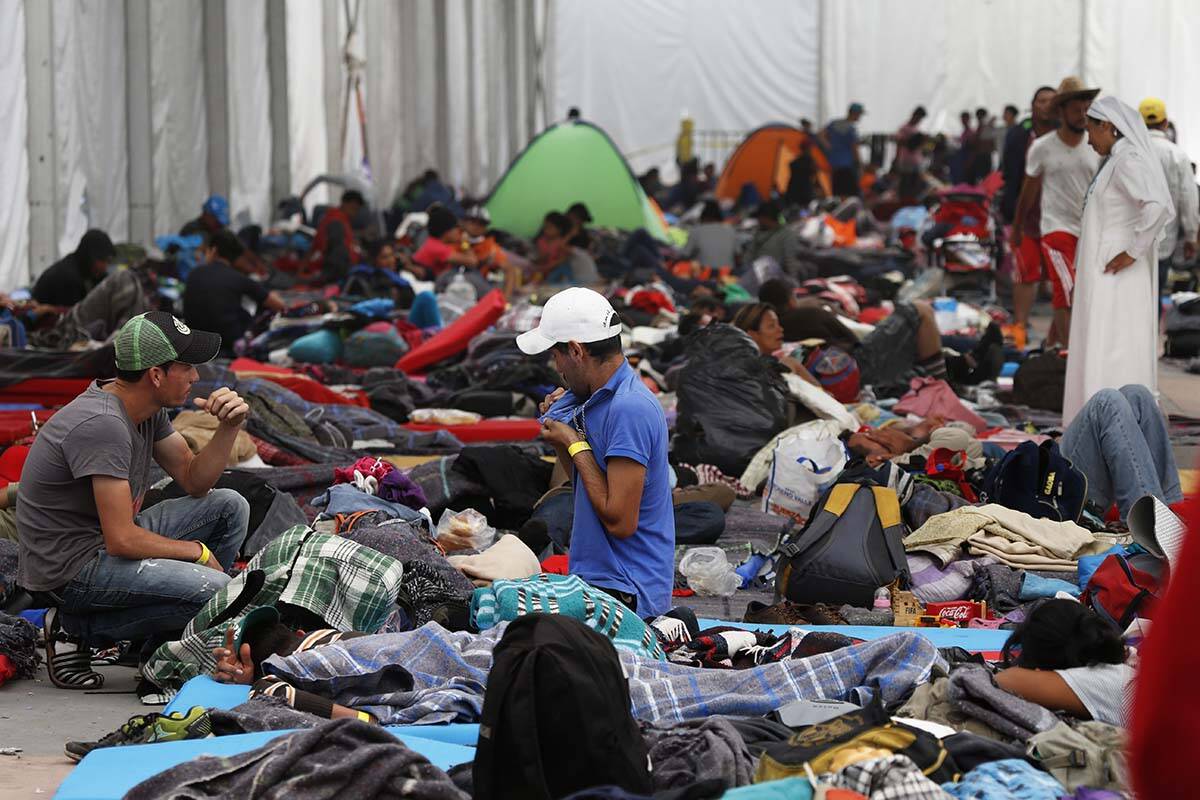 Central American migrants settle in a shelter at the Jesus Martinez stadium in Mexico City, Tue ...