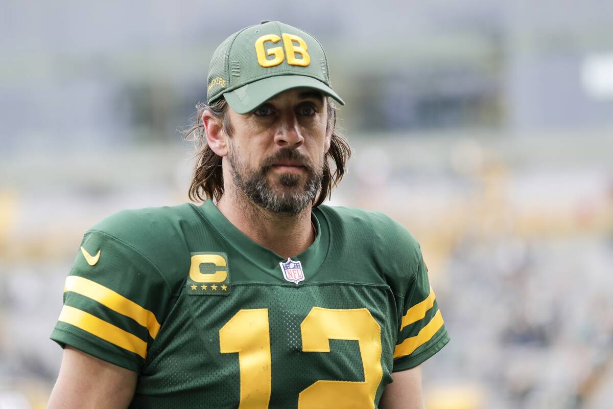 Green Bay Packers' Aaron Rodgers walks off the field after an NFL football game against the Was ...
