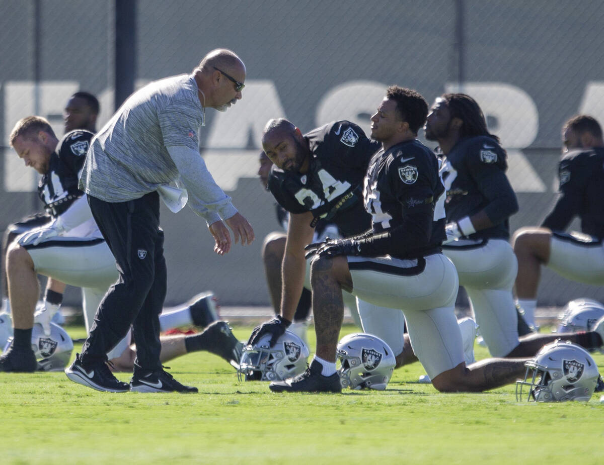 Raiders interim head coach Rich Bisaccia speaks to Raiders safety Johnathan Abram (24) during a ...