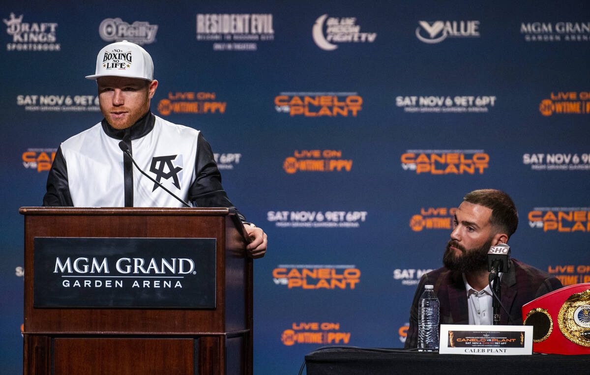Boxer Canelo Alvarez makes some comments as Caleb Plant listens intently during the final press ...