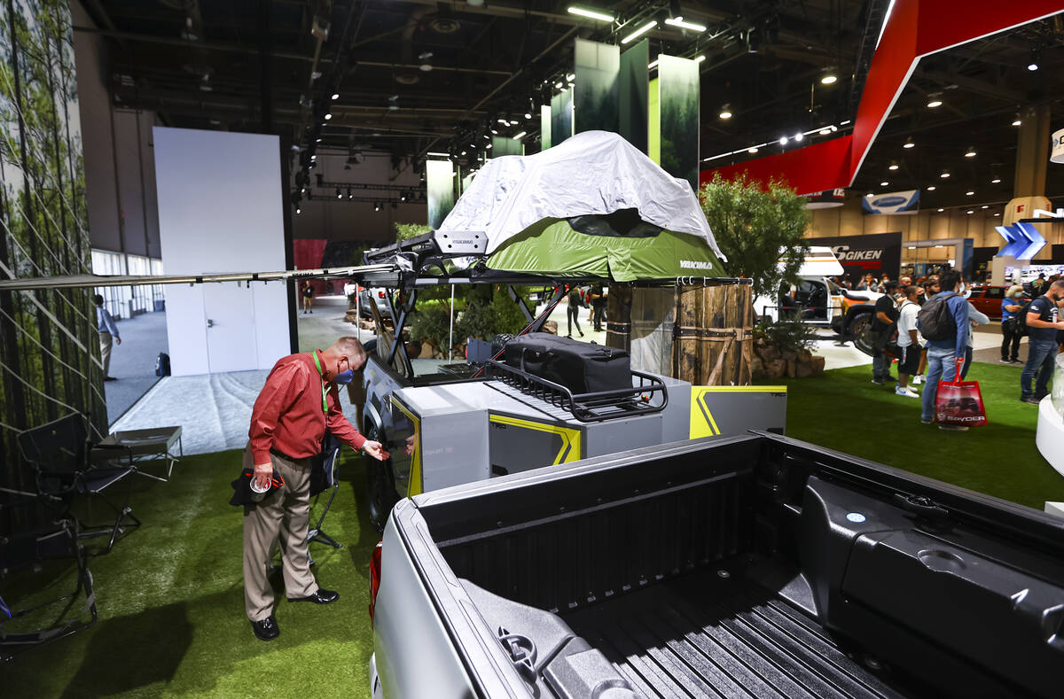 Attendees check out the Toyota Tacoma TRD Sport Trailer overlanding concept at the Toyota booth ...