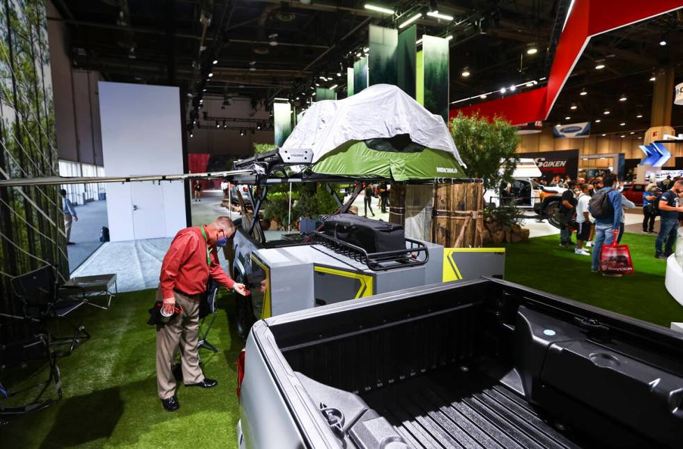 Attendees check out the Toyota Tacoma TRD Sport Trailer overlanding concept at the Toyota booth ...