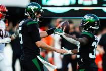 New York Jets quarterback Mike White, left, and Michael Carter celebrate after an NFL football ...