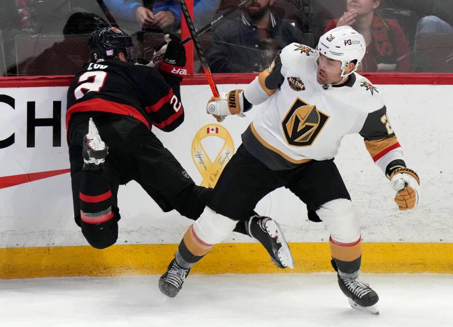 Vegas Golden Knights left wing William Carrier sends Ottawa Senators defenseman Artem Zub, left ...