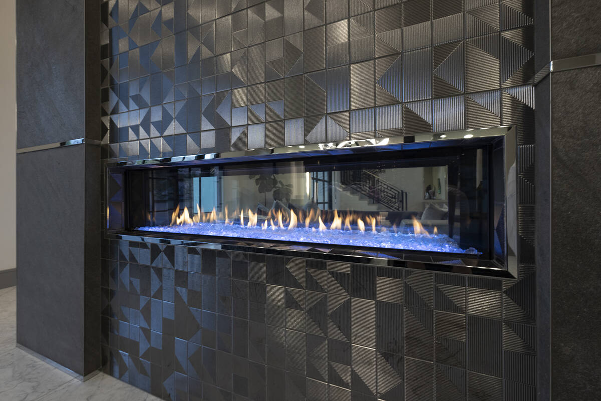 The modern fireplace is a focal point in the living area. (Las Vegas Sotheby’s International ...