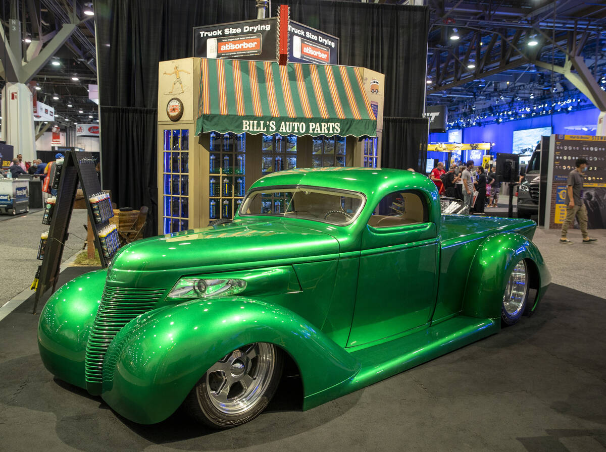 A custom car sits about a display for The Absorber within SEMA at the Las Vegas Convention Cent ...