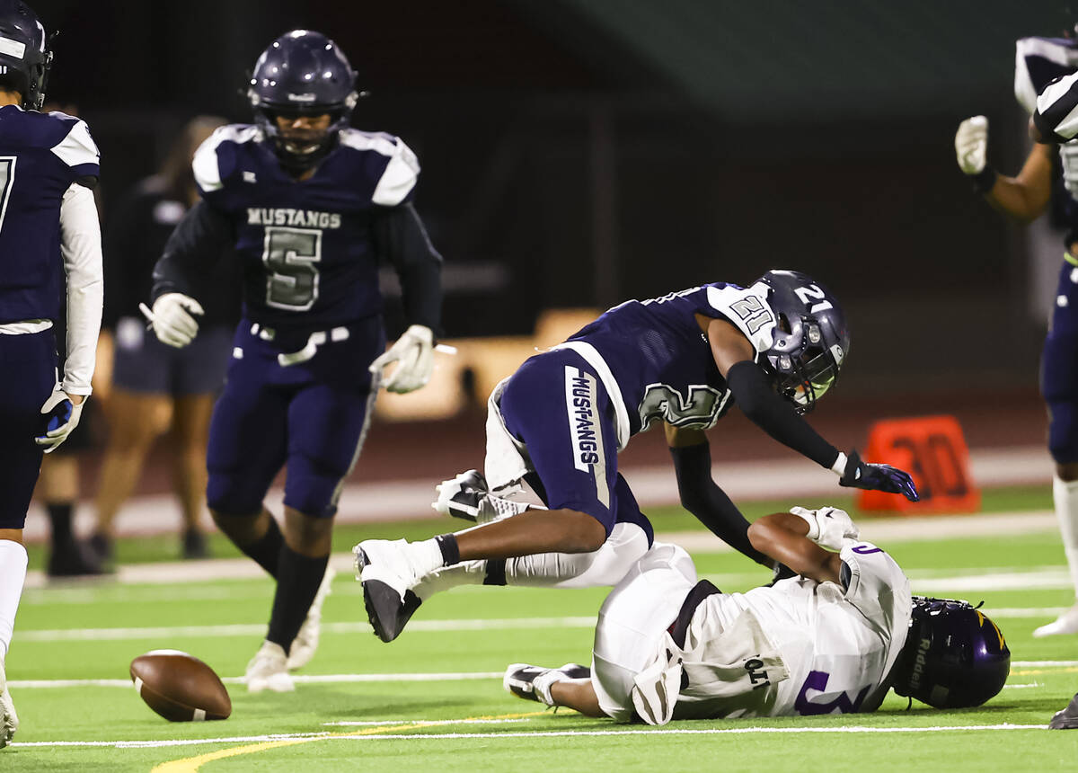 Shadow Ridge's Jeremiah Campbell (21) breaks up a pass intended for Durango's Jaxon Young (3) d ...