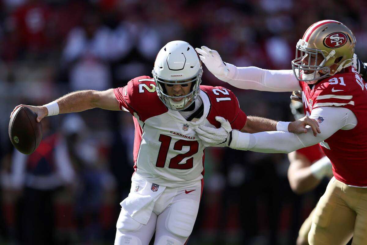 Arizona Cardinals quarterback Colt McCoy (12) is pressured by San Francisco 49ers defensive end ...