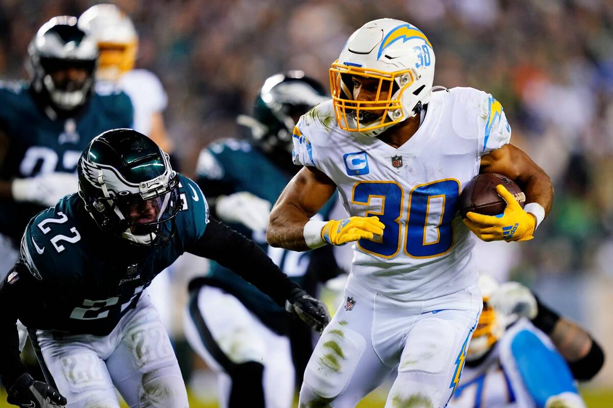Los Angeles Chargers running back Austin Ekeler (30) runs with the ball past Philadelphia Eagle ...