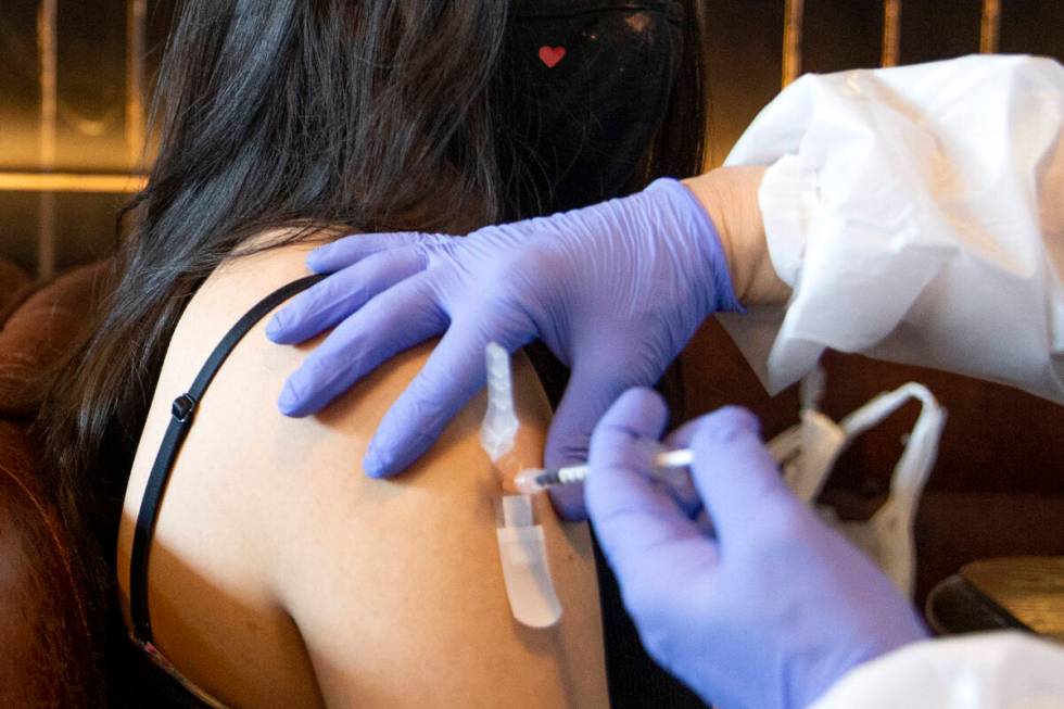 Audrey Vallapudua, of Las Vegas, receives the Pfizer COVID-19 vaccine during a pop-up vaccinati ...