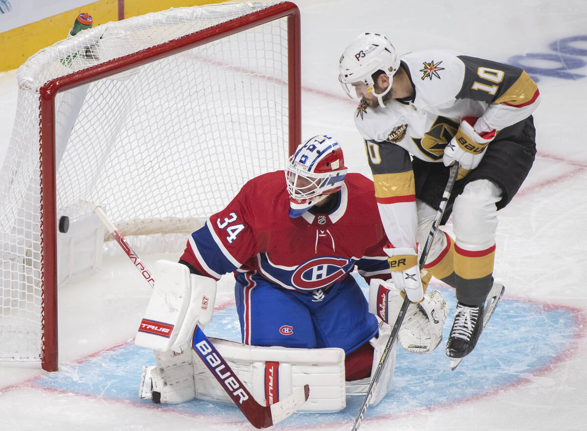 Vegas Golden Knights' Nicolas Roy (10) jumps as Montreal Canadiens goaltender Jake Allen, left, ...