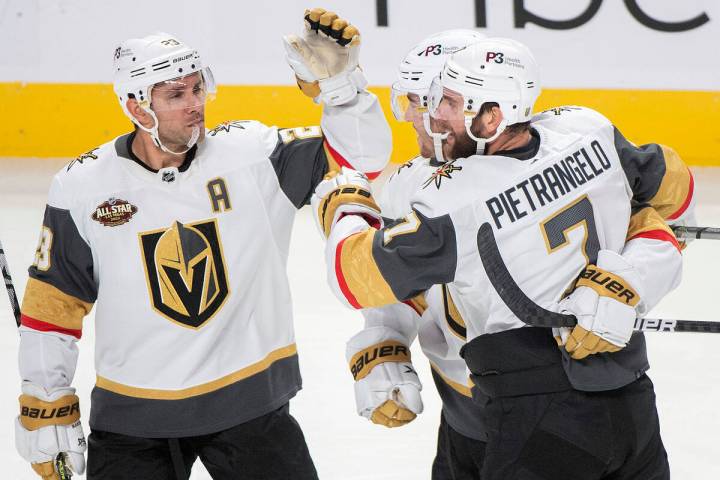 Vegas Golden Knights' Dylan Coghlan, center, celebrates with teammates Alex Pietrangelo (7) and ...