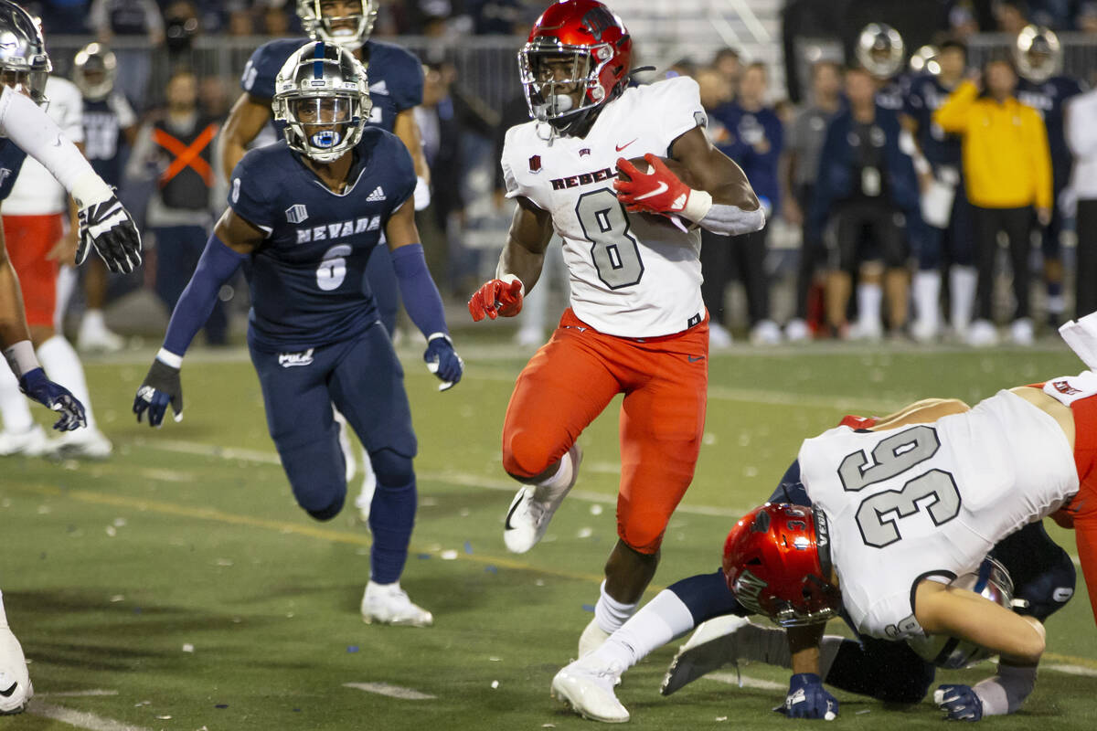 UNLV running back Charles Williams (8) runs for a touchdown against Nevada in the second half o ...