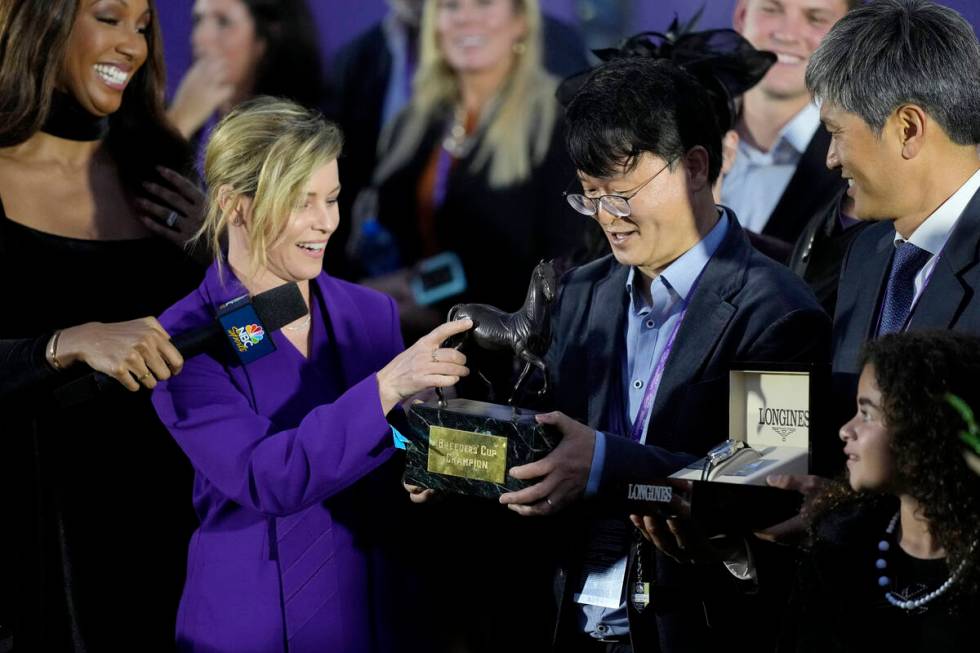 Actress Elizabeth Banks, middle left, presents the Breeders' Cup champion award to Lee Jinwoo, ...