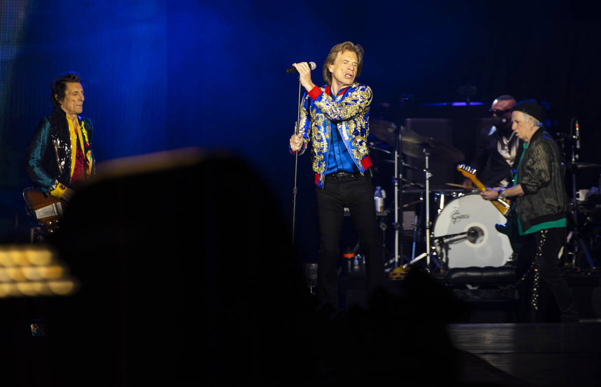 Mick Jagger of The Rolling Stones, center, performs alongside Ronnie Wood, left, and Keith Rich ...