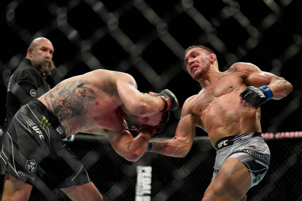 Michael Chandler, right, lands a punch against Justin Gaethje during a lightweight mixed martia ...