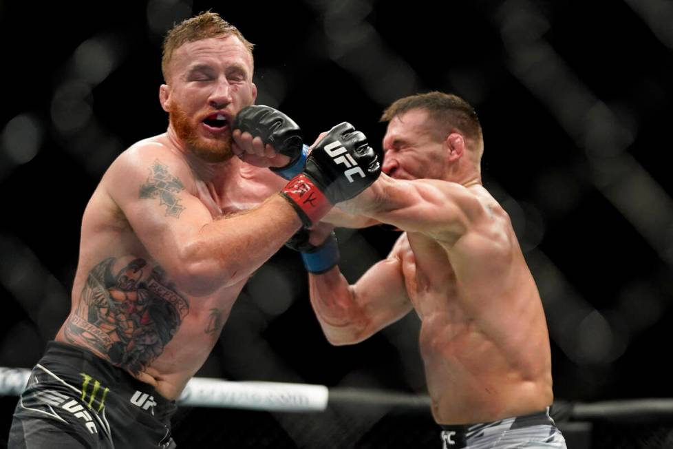 Michael Chandler, right, lands a punch against Justin Gaethje during a lightweight mixed martia ...