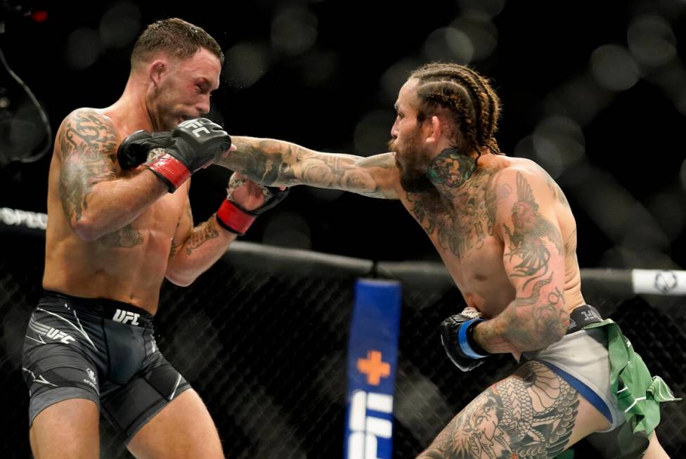 Marlon Vera, right, lands a punch against Frankie Edgar during a bantamweight mixed martial art ...