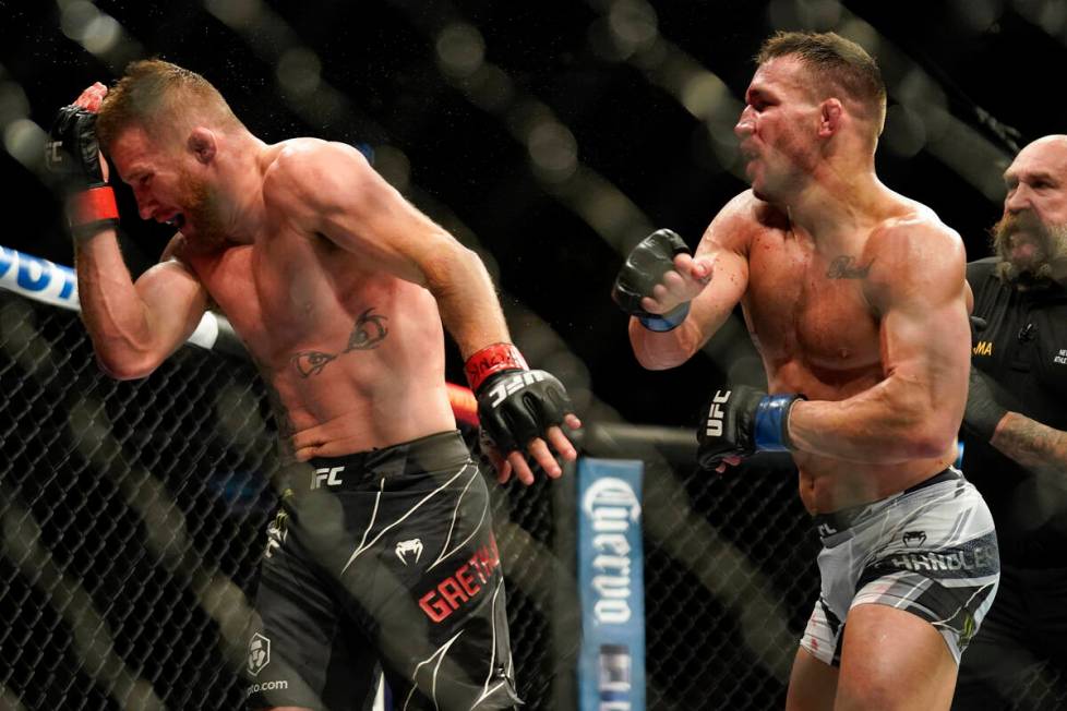 Justin Gaethje, left, reacts to a punch from Michael Chandler during a lightweight mixed martia ...