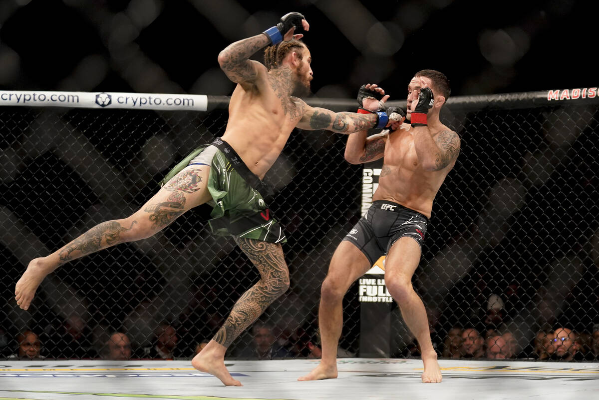 Marlon Vera, left, throws a punch against Frankie Edgar during a bantamweight mixed martial art ...