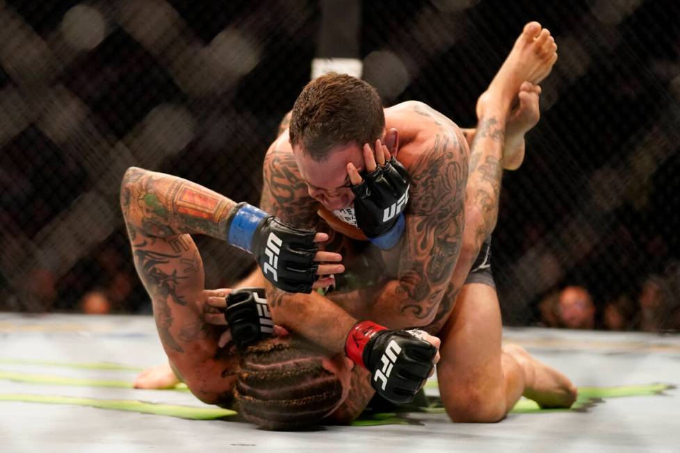 Frankie Edgar, top, grapples with Marlon Vera during a bantamweight mixed martial arts bout at ...