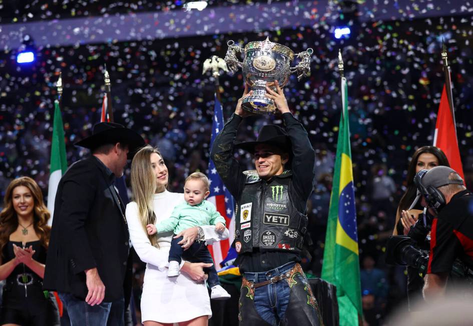 Jose Vitor Leme celebrates alongside his son, Theodoro, and wife, Amanda, after becoming the ba ...