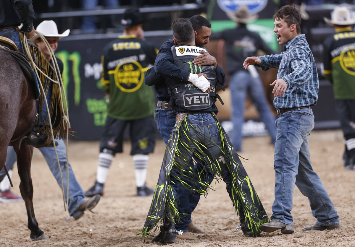 Jose Vitor Leme, facing away, celebrates after becoming the back-to-back PBR World Champion dur ...